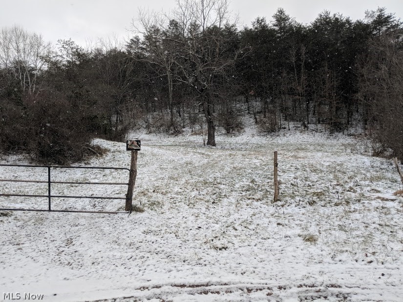 A great piece of land just minutes from town and shopping. This wooded parcel offers plenty of wildlife and even has pasture area. County road frontage for easy access. Located between Pettyville Road and Gihon Road on Hope Hill Road. City water available along Hope Hill Road. Offers some open area along the road for storage or garden area. Small shed on property near Pettyville Road does not convey - belongs to the neighbor who has been using the area for gardening. Bring your home plans and get started on your new home this spring. Priced as Surface only. Should it be determined that Sellers have any oil, gas and mineral rights under this property they will be glad to entertain offers. Owners share of ogm included for a total sale price of $210,000.00