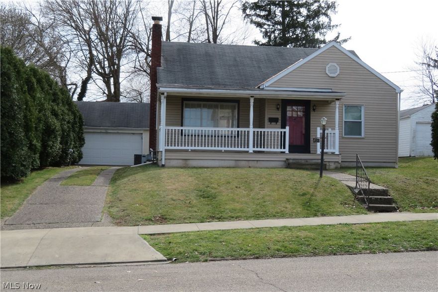 This 1.5 story house has newer windows and vinyl siding with a front porch for relaxing. There is a two-car garage, a back patio with a ceiling fan, and a private, fenced back yard. Inside you are surprised to find so much living space. Hardwood floors throughout, an ornamental gas fireplace  and built in shelving on one wall of the dining room. Main bedroom is on the first floor and 2 bedrooms are upstairs with a half bath. The lower level has a bar and a shower. Refrigerator, range, dishwasher, dryer, washer, and freezer stay. They are believed to work but not warranted. With a little work this house could be brought to its former luster. Property is being sold in its present condition. Cash or conventional financing only.