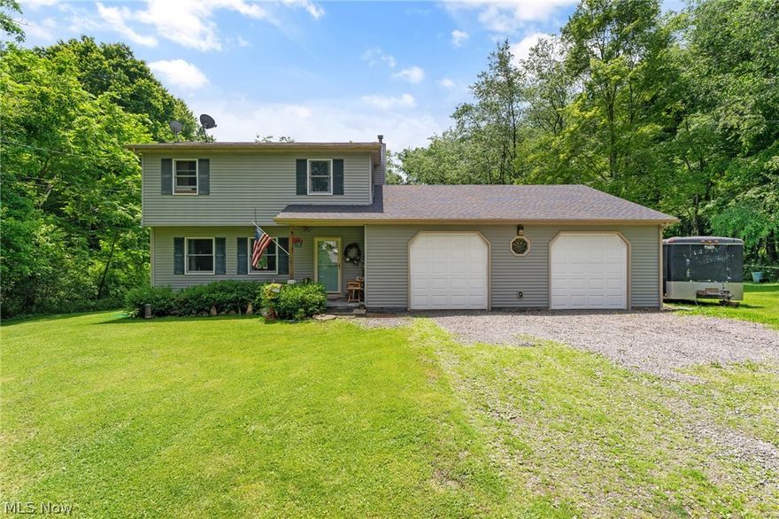 Welcome to 7548 Mack Dr! This wonderful 2 story has a lot to offer to its next homeowner!! This house is nested right in Hubbard Township surrounded by hard woods. As you walk through the front door, you've see the beautiful new flooring throughout carried through the entire first floor. The large living room has wide door ways that open into the eat in kitchen area. There's a nice area for a dining room table, updated light/fan fixtures that brighten the way to your huge kitchen! This kitchen is large enough for an portable island, has tons of wood cabinet space, Formica counter tops and space for the family. First floor bedroom with access to the back deck and tucked away next to a full bathroom. Upstairs offers an huge master with tons of closet space and another bedroom with good closet space. Full bathroom with nice vanity and tub surround. The garage is an oversized space, great for someone with hobbies or needs more space! It also has access to walk up attic that has a ton of st