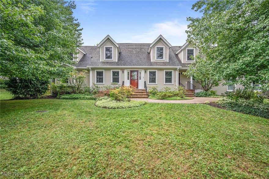 This charming cape cod in Bramble Farms (South Russell) is on 2.25 acres on a shared drive off Bell Road with 4 bedrooms and 4 full baths. The home is set back among mature trees, perennials and native plantings for a gardener’s delight.  The first level is fully functional for one floor living: living room, eat-in kitchen, primary bedroom suite, great room, office, second full bath, laundry room and screened in porch, all freshly painted with beautifully refinished cherry hardwood floors throughout.  Need more space? Upstairs are three more bedrooms, two full baths and a large bonus space with two window seats! 

The fabulous white kitchen with granite counters and stainless steel appliances has a large center island, adjacent eat-in area with wood-burning fireplace and opens to the cathedral great room.  The former dining room is now an office but could be a guest room (full bath across the hall), nursery, or perhaps an amazing pantry with hidden door!  Half of the lower level has a drop ceiling and carpet for informal use (fitness equipment, play area).  The oversized 3-car garage provides plenty of room for vehicles and extra storage.

The owners are going to miss the three-season sunroom off the great room for morning coffee and evening sunsets.  The great room has a stone, wood-burning fireplace and windows on all walls, showcasing the changes in season throughout the year.  Most of the projects to expand the home and make major improvements began in 2010 (see supplements).  Make a call to see this wonderful home!