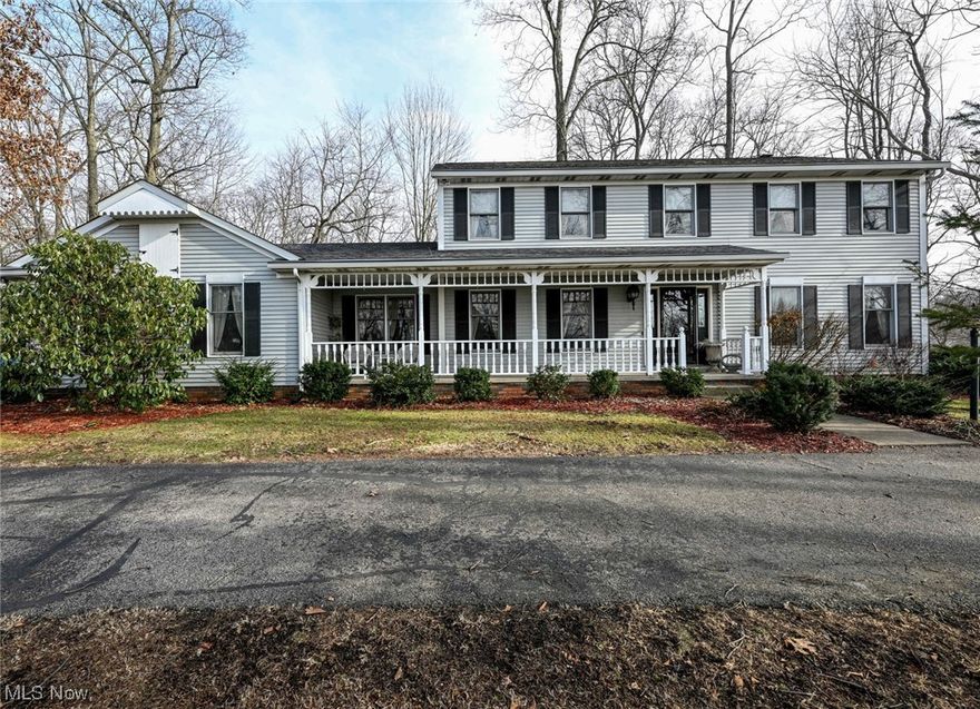 A rare find is now available!  This 5 BEDROOM, 3 BATH HOME w/ a 3 CAR attached & 3 CAR BONUS GARAGE is ready for YOU!   Located in the beautiful Brookhill Estate subdivision in Mogadore.  Situated on 1.34 acres of serene wooded property!  Large front porch is waiting for your rocking chairs to it & enjoy the neighborhood.  Welcome into the spacious foyer at the center of the home.  Formal living room to the right & formal dining room to the left.  Large eat-in kitchen offers a casual dining area, tons of cabinet & counter space, island, stainless appliances & 3 bowl sink w/ fantastic view of the back yard.  The new laminate flooring runs through the hall way & half bath.  Cozy family room has great natural lighting & fireplace.  Bonus screened in porch as well as an enclosed porch!  There is also a main floor bedroom or office.  Master suite w/ vaulted ceiling, walk in closet & huge bathroom is amazing!  Laundry in in the hallway closet.  Another full bathroom w/ sky lights & 3 more be