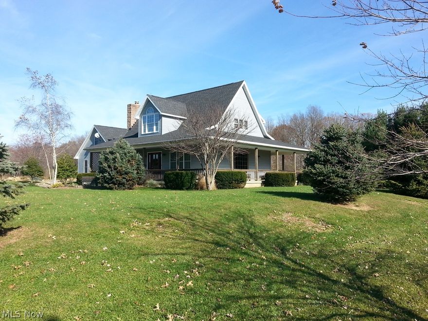 Excludes: Yard ornaments, antique wall phone and attached dining area china cabinet.  Picturesque property on 1.3 charmingly landscaped acres.  Three-sided wraparound porch, curved walkways, koi pond, even a real working waterwheel.  Inside you'll find a fireplaced living room with 20 foot plus vaulted ceiling, balcony, loft, and open stairway.  Open concept kitchen - living - dining, first floor office, first floor laundry, bedroom and full bath each floor.  *A lot to fall in love with already here, but don't overlook the large heated garage/workshop with hot and cold water, 220 electric, and floor drain, plus the large storage attic above with powered stairway.  A rare find just minutes to Atwood Lake.  *Loft could make third bedroom.