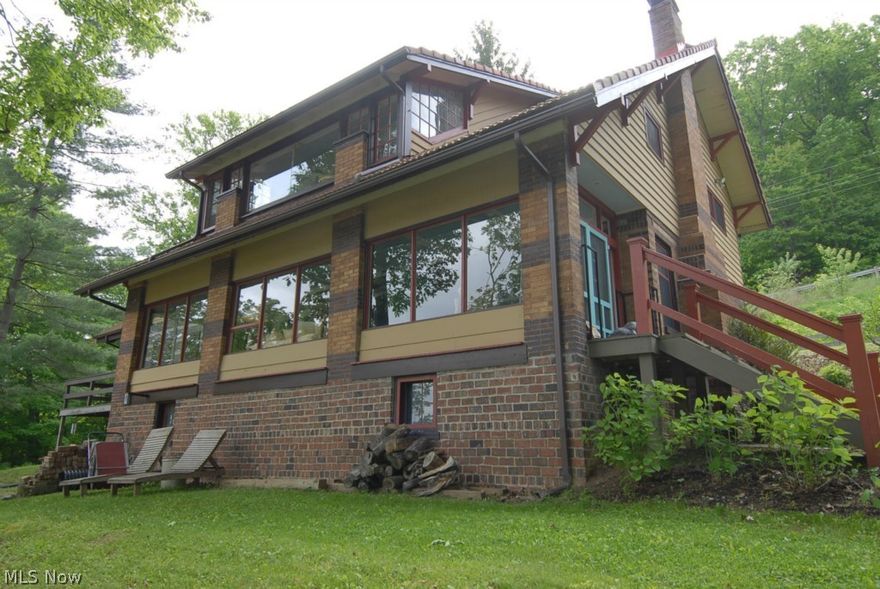 This home is a perfect peaceful get away! Enjoy as your personal residence or operate as a Bed and Breakfast.  Each room has it's own private bath.   Located directly on the Muskingum River overlooking Lock 11 at Ellis Dam, this home is a true beauty.   The panoramic water view is amazing from the second floor sleeping porches and main floor front porch.  Present owners have lovingly remodeled the interior taking care to maintain much of the original decor as possible.   Updates include, kitchen, baths, bedrooms, flooring and more.  All nestled on a scenic 4.35 acre wooded lot.  This home is located well above the flood plain and will not require flood hazard insurance.