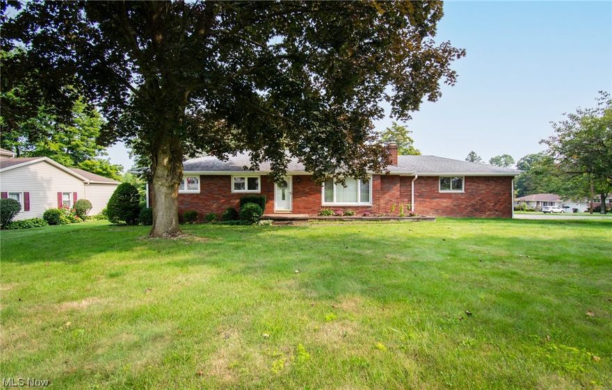 Look no further! This beautifully maintained brick ranch is situated on a half-acre corner lot in the desirable area of New Middletown. As you enter, you are greeted into the first of two living rooms, featuring a fireplace and large picture window, where you will enjoy the view of the mature trees in the front yard. Around the corner, the hallway will lead you to your two secondary bedrooms boasting hardwood flooring, across the hall from a shared full bathroom with tub/shower combo. Tucked away in the back corner of the home is your master suite, which offers a wide entry walk-in closet, secondary wall closet, and generously sized ensuite bathroom. Making your way back to the heart of the home, you will find a fully equipped kitchen - appliances included - and a floating countertop island, for added convenience. Just off of the kitchen is your formal dining room and a second living area with access to the side and back yard. If all of that's not enough, fall in love with the amazing enclosed porch, the perfect spot for your morning coffee and evening wind down! Heading downstairs, the very spacious lower level has a full bathroom with a walk-in shower, and several large sectioned off rooms with plenty of room for activities - just waiting for your final touch! Electrical service was updated to 150 amps last month. Call today to schedule a private showing with your favorite agent!