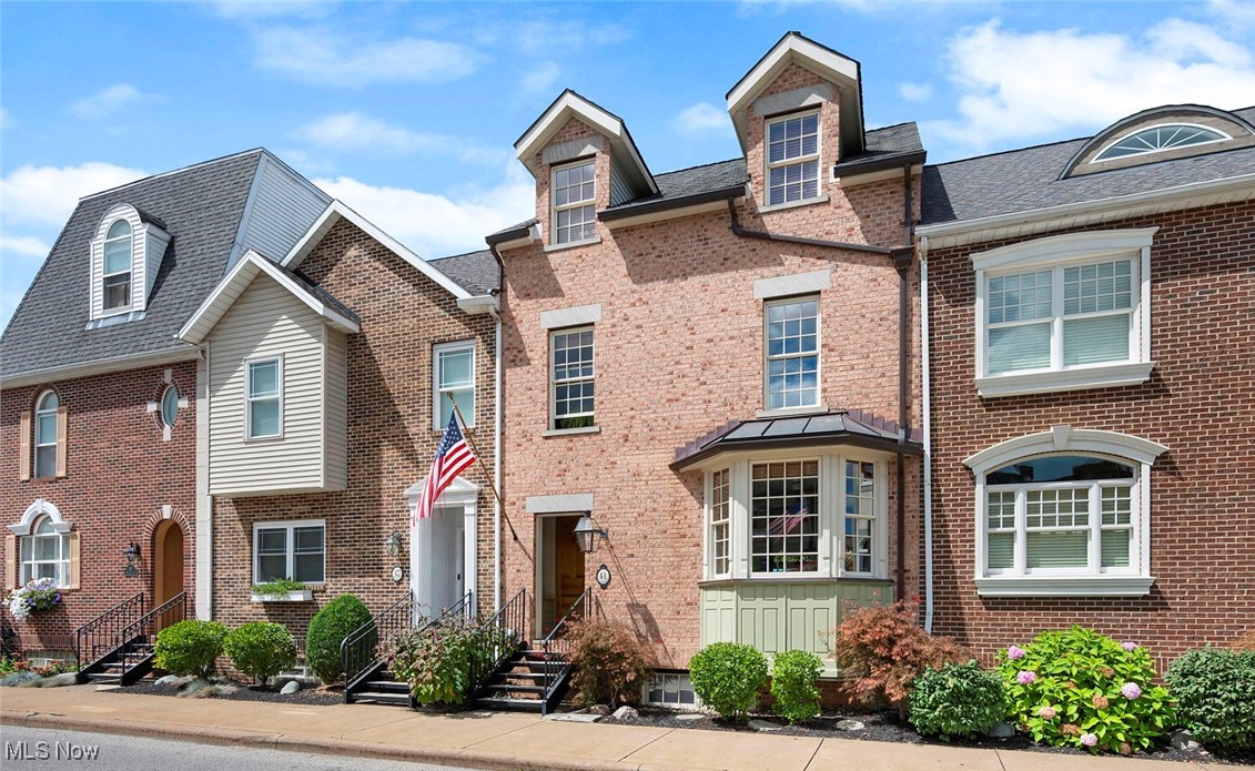 You actually can have it all. A newer construction townhome with high ceilings and a spacious open floor plan - along with cypress doors from a 19C house in New Orleans! All the vibrance of living right on the Triangle in downtown Berea at your front door -and the most picture-perfect, quiet setting directly on the Rocky River on the terrace in the back. Beautifully custom-built home with numerous recent updates, including top-of-the-line Architectural Series Pella windows throughout, as well as new patio French doors. The original siding on the rear facade has been replaced with James Hardie "Hardieplank" for easy maintenance, and copper gutters and downspouts, and a copper roof over the bay window were installed on the front facade. There are sandstone lintels on all of the front facade windows, and Berea Sandstone on the front porch and the foyer flooring. Oak hardwood floors are throughout the house, and beautiful, custom oak woodwork on first floor. All the interior doors are 125+ year-old cypress from New Orleans. The 100+ year-old double front doors are from Chicago. The doorbell and all door hardware are authentic to the same period and fully restored. The gas light and mailbox are handmade of copper from the Bevolo Gas & Electric Lights in New Orleans. The lights above the kitchen sink and the front porch light are from Halle's Dept Store, downtown! Elfa (Container Store) closet systems are in the master bedroom, office, and laundry room. A new Container Store murphy bed and storage cabinets are in the office. In the kitchen there's a newly installed gas 4-burner Wolf cooktop. And the wonderful gourmet workspace is completed with a GE double gas oven, all set in gorgeous Kraftmaid maple custom cabinetry. Elegant custom bathrooms and 4 large bedrooms complete the picture. The entire interior has been freshly painted. Walk literally across the street to a cafe, a bar, a bakery, or just a block to Coe Lake! The perfect place to live. Open Sat, 11-1, Sun. 1-3