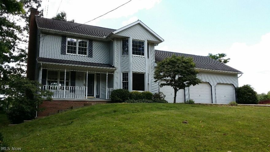 Spacious 2 story home with 3 car attached garage and 2 tier deck.  Nice kitchen with dinette, first floor laundry and half bath, formal dining room and living room with fireplace.  4 bedrooms including master suite with ample closet space and master bath with jetted tub and shower.  Bedroom 4 has private staircase.  Full walk out  basement.  Perry schools.  Being sold as is, needs some tlc.