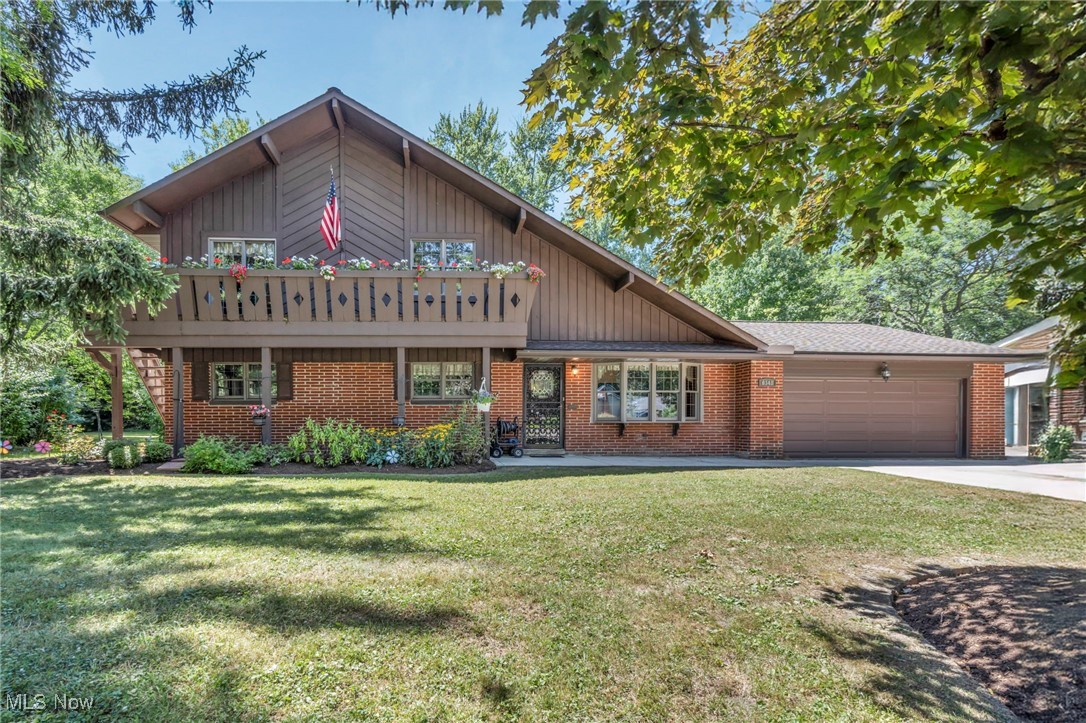Step into this picturesque Swiss Chalet! Meticulous landscaping and a welcoming facade greet you. An inviting balcony with flower boxes enhances curb appeal. Inside, the soaring vaulted ceiling creates an airy atmosphere. The living room boasts a bay window and decorative fireplace. The dining area opens to a deck via sliding glass doors for seamless indoor-outdoor living. A lofted study overlooks the living room, accessing the balcony (rebuilt 2017). The kitchen features Formica countertops, appliances, and an adjustable built-in table. New appliances (dishwasher, range, washer, dryer) in 2024 offer modern convenience. A wood-burning stove adds character. Laundry is conveniently located off the kitchen. The first floor has two bedrooms, including a primary suite with a private bath, and two remodeled bathrooms (2015, 2024). The eat-in kitchen connects to a four-season room (converted 2012) with a gas fireplace and AC for year-round comfort. Updates include vinyl siding (2019), new rear/side windows (2018), and a new roof (2008). Enjoy a two-car garage and a fenced backyard with a deck. No basement means low maintenance! Schedule a showing today!