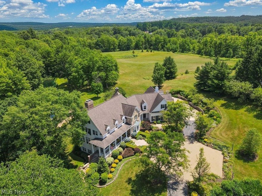Nestled on two parcels equaling 15+ picturesque acres just five minutes from downtown Chagrin Falls, this exceptional one-of-a-kind property embodies the essence of country living w the convenience of living in Chagrin Falls. The property has two serene, stocked ponds, a charming guesthouse, a classic barn and meticulously maintained meadows. A long, private drive leads to the main residence, a comfortable 5-bedroom, 5-bathroom retreat designed for everyday living and entertaining. The main floor opens to living room with oversized windows that flood the space with natural light and offer sweeping views of the surrounding exterior. The spacious kitchen is a chef’s dream, complete w massive butcher block island, upscale appliances and natural stone countertops. An inviting living area adjacent to the kitchen is the perfect spot for casual living, all framed by the stunning exterior landscape. The screened porch equipped with fireplace has a gorgeous setting for outdoor entertaining with a view. Convenient service entrance leads to mudroom w storage + direct access to an unbelievable laundry room. The first-floor office w French doors includes custom-made cabinetry and a perfect space for home office or study area. The owner’s suite is a true sanctuary, w windows overlooking the lush backyard, cozy fireplace, private upper-level office, spacious walk-in closet and a luxurious en-suite bath. Three additional bedrooms + two full baths with landing area provide ample space. Second laundry is near bedrooms. The finished lower level walkout includes workout area and hangout spaces. Outdoor patio + kitchen + fire-pit are just some of the unbelievable features of this property. Fishing, paddle boarding, hiking and exploring all in your own backyard. Additional parcel has been mowed for sports and+playing fields. 3 bedroom/1.5 bath guesthouse for friends, family or income producing option! Original white barn w new doors. Must see and best option for a hobby farm in town!
