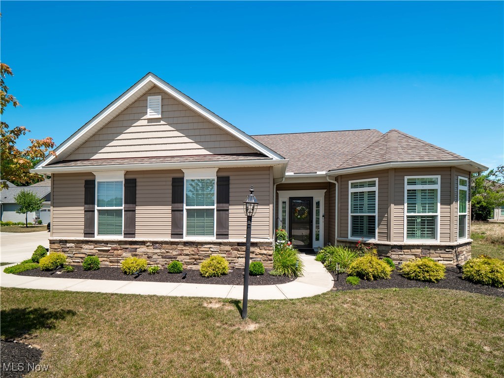 Why wait to build when you can move right into this impeccably maintained 3 bedroom, 2 full bathroom ranch home? Situated in the desirable low-maintenance community of The Reserve at Pine Lakes in Strongsville, this Cambridge model built by Kensington Homes offers the convenience of true first-floor living paired with thoughtful upgrades and modern style. Step inside to find an open layout featuring warm wood flooring and elegant decorative trim. The spacious kitchen is the heart of the home, boasting a large center island with bar seating, beautiful white cabinetry, stainless steel appliances, and plenty of prep and storage space. There’s also a designated dining area, perfect for more formal meals, all open to a light-filled family room that creates the ideal space for entertaining or relaxing. Down the hall, the expansive primary suite offers a peaceful retreat with a tray ceiling, a generous walk-in closet, and a luxurious en-suite bath complete with dual vanities, a walk-in shower, and a linen closet. Two additional bedrooms offer flexible living space, making it a perfect option for a guest room or home office. The second full bath features a glass-enclosed shower, and the home also includes a spacious laundry room with a utility sink, plus the washer and dryer stay. Custom plantation shutters and all-new light fixtures add to the stylish, move-in-ready appeal. A rare and highly sought after feature in this home is the oversized three-car garage, offering extra space for vehicles, storage, or hobbies. Step outside to enjoy the beautifully landscaped corner lot with a large covered patio that extends to an additional concrete pad which is ideal for grilling or outdoor dining. The homeowners association takes care of lawn maintenance, landscaping, and snow removal, offering a truly low-maintenance lifestyle. Come see today!