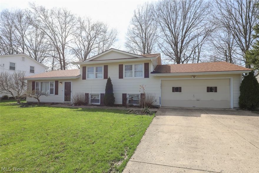 Adorable 3-4 bedroom split level home with a 2 car attached garage in a great neighborhood.  This home is move in ready with new paint and carpet throughout.  Spacious living room opens to a formal dining room with sliding doors to the covered back patio.  Updated kitchen with appliances.  3 bedrooms and a full bath on the upper level.  The lower level has a large family room/rec room that is currently being used as a master bedroom.  Fenced in back yard with back patio and shed.  Home warranty is included for a worry free purchase!  (This must see home is in Canfield mailing with Austintown school District).  Call today to schedule a private tour!