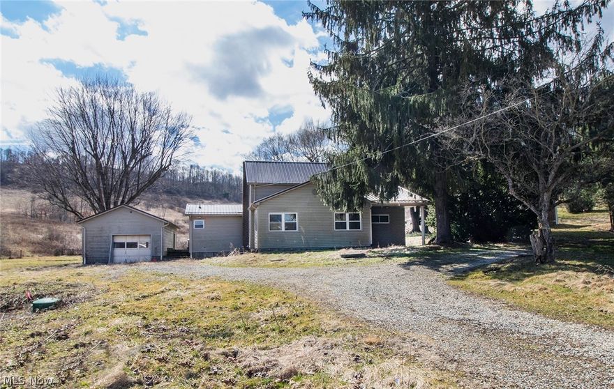 This property is a hunter's and fisherman's paradise! Approximately 51 acres with abundant wildlife and stock pond. This 3 bedroom, 2 bath newly remodeled home offers an eat-in kitchen, laundry room/mud room, and 2 covered patios. The tiled kitchen counters makes canning your produce from the garden easy and worry-free. Master bedroom and master bath are on the main level. One car oversized detached garage has ample room for your vehicle and lawn mower, plus there is a 24'x40' pole barn/shop, a split roof livestock building, and additional outbuildings for livestock or storage of your equipment or toys. Home has free gas and all mineral/gas rights owned will transfer. Minutes from Sugarcreek and New Philadelphia. Agent owned.