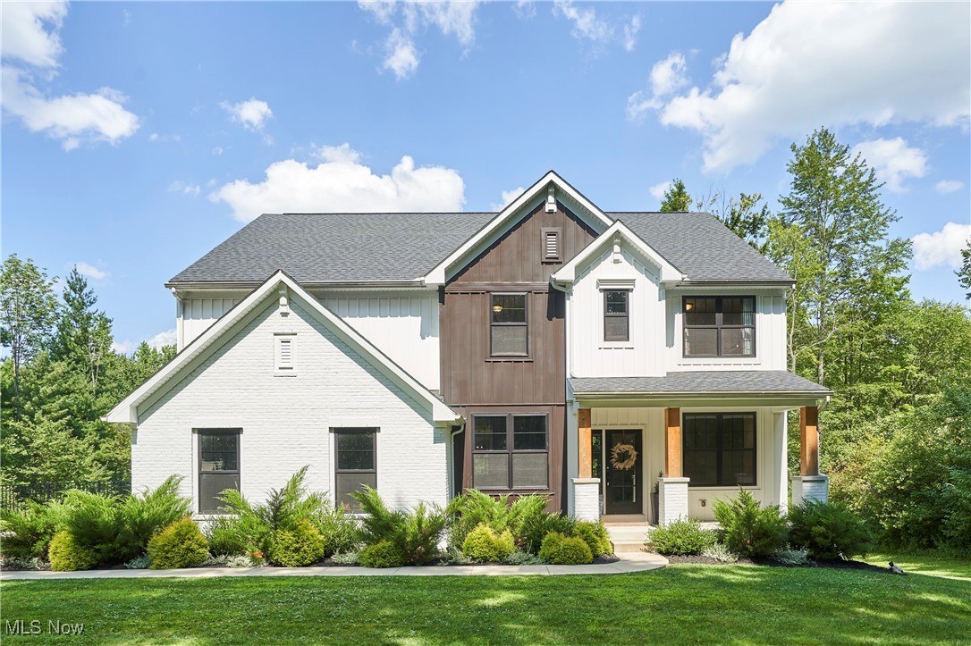 Welcome to this stunning & tastefully designed 5-year-old 4BR 3.5BA craftsman colonial tucked away on a private drive in Bainbridge Township! Comfortably situated on 5 wooded acres, this property offers exceptional privacy with a fenced backyard and wooded boundaries on all sides. Waltz in through the open foyer admiring the front formal living and dining rooms on either side to a bright and dramatic double-story family room with a cozy fireplace and wall of windows that fill the space with natural light. The open-concept floor plan features a spacious eat-in kitchen with quartz countertops, breakfast bar island, and access to a 2-tier TREX deck- offering an array of dining options as well as a half bath and mudroom. Upstairs you will find the primary suite w/ WIC, dual sink vanity, and walk-in shower. Three additional bedrooms all include walk-in closets, and the convenience of a second-floor laundry room adds to the appeal. The walk-out lower level is partially finished with a full bathroom, abundant storage, and great potential for expanded living space. A rare opportunity to enjoy modern comforts surrounded by natural beauty! Conveniently located less than a 10 min drive from Chagrin Falls, Solon & Aurora.