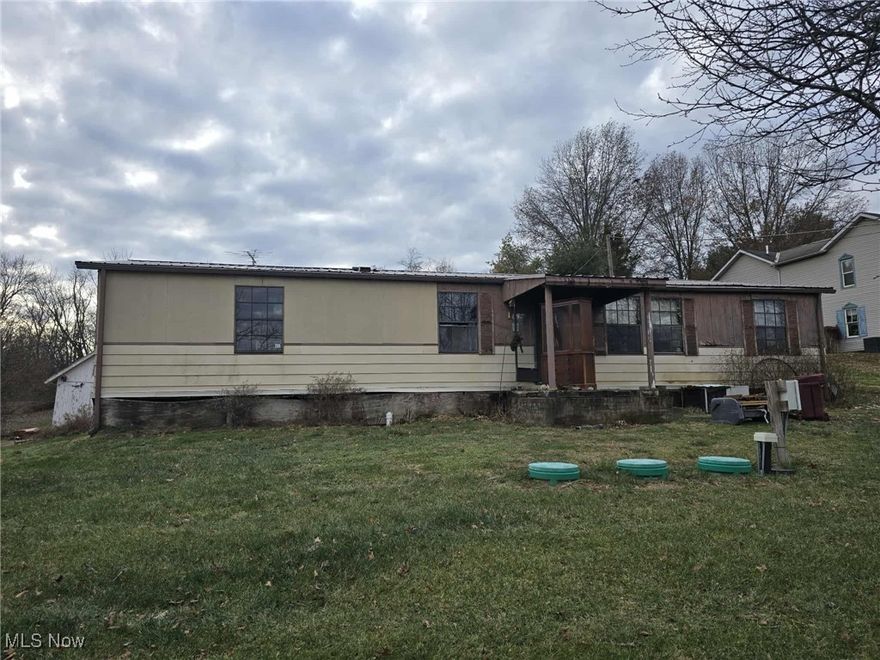 Buy this for the garage and fix the house to your liking! Large detached garage with space to run your own business. The garage has a second floor that could be made into living space. East Muskingum schools on almost an acre of ground.