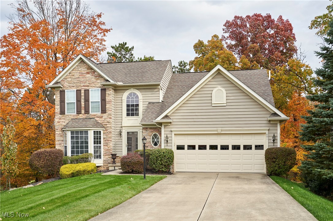 Nestled against the scenic Sand Run Metro Park, this spacious 3-bedroom, 2 full and 2 half bath home offers modern comfort with a serene, natural backdrop. The open floor plan, enhanced by high ceilings and abundant natural light, highlights the fully renovated kitchen, which opens to a stunning, vaulted Great room with a stone fireplace. Perfect for year-round enjoyment, the four-season sunroom and the expansive deck and patio overlook lush wooded views and a large backyard, creating an ideal space for relaxing or entertaining. The first-floor primary suite includes a walk-in closet and full bath. A convenient mudroom and half bath complete the first floor. Upstairs, two spacious bedrooms, a loft, and a full bath provide additional living space. The finished walkout lower level adds over 900 square feet, including a family room, rec room, and half bath. Located within the highly-rated Revere School System. Fantastic location, close to Cuyahoga Valley National Park, Blossom Music Center, Fairlawn shops & restaurants. Some recent updates include a new refrigerator and carpet in 2023, and a washer and dryer from 2020. Schedule your private showing today!