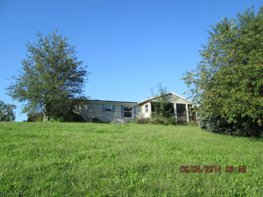 Large three bedroom home with two baths, a covered porch, deck and 2 car garage all on 5+ acre lot.