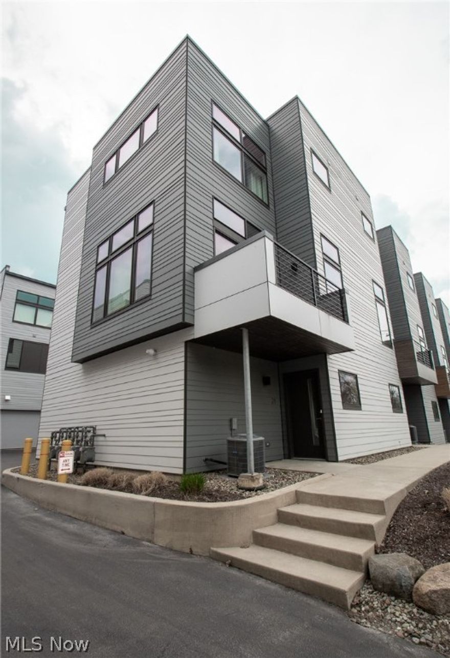 A MUST SEE! Absolutely stunning townhome in the award winning Riversouth Modern ECO-Home community!  Overlooking the Emerald Valley of the Rocky River Reservation Cleveland Metroparks, this home offers luxury, city living with nature at your back door.  Fully updated and meticulously maintained, this 3 story end unit townhome is larger than the inner units, and outside wall has floor to ceiling windows-  warm, natural sunlight fills the entire place, upstairs and down.  The main floor features an open concept living and dining area with beautiful hardwood floors, luxury kitchen with Quartz countertops and island, high-end cabinetry and stainless steel appliances, full bathroom and access to your own private deck/balcony. Two great sized bedrooms upstairs with separate laundry room-  2nd bedroom being ideal for your home office or guest room, or whatever you desire. Master bedroom with bathroom ensuite, granite top vanity, large walk-in shower and closet. 2 car attached garage with priv