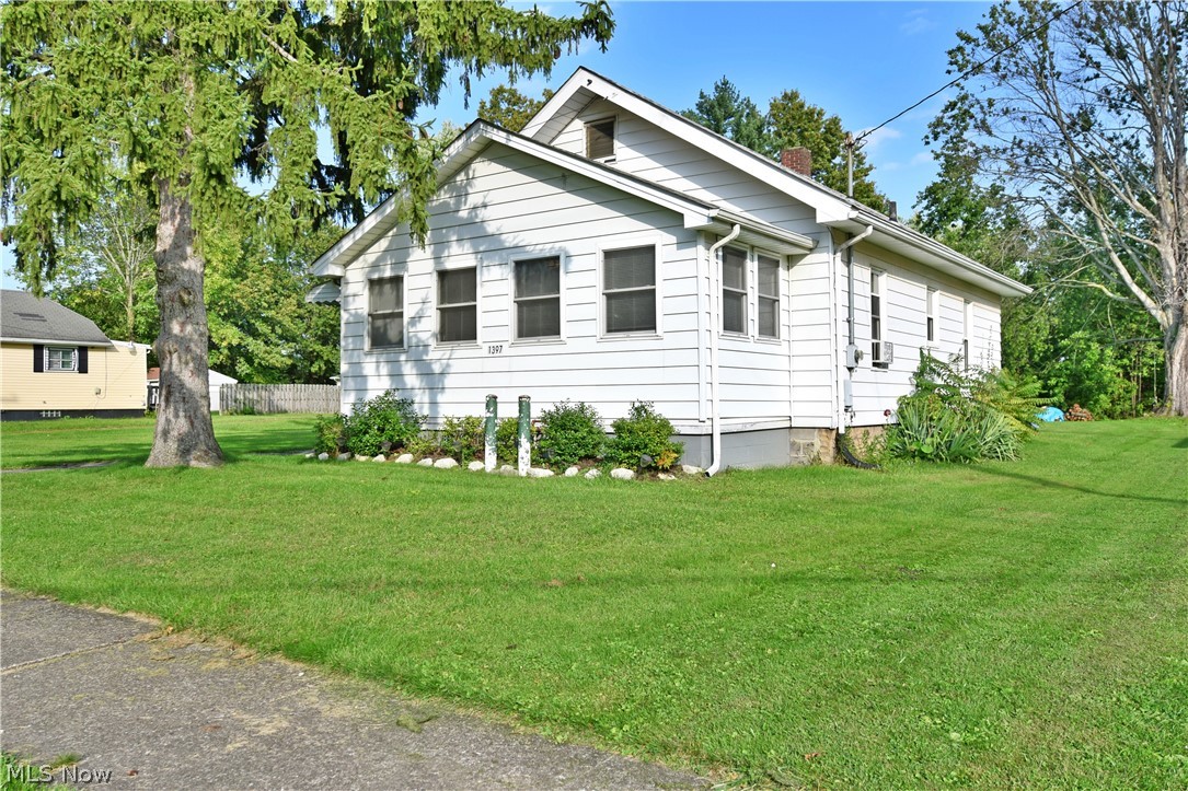 You won’t want to miss this excellent home or investment property alike! This cozy two-bedroom Warren home has everything you’ve been looking for, to include an oversized property with a huge side lot for expansion or recreation. The front of the home is graced with a relaxing, window lined sunroom that makes for a great three-season hangout. Warmer days are best enjoyed in the rear facing screened in patio space. Inside, you’ll find a welcoming carpeted living room with a sculpted plaster archway leading into the ample kitchen. Here, casual eat-in dining joins an array of wooden cabinets as hardwood style floor runs below. Basement access is right around the corner. A short hall bridges the two spacious bedrooms, each with personal closet space. A brightly lit full bath separates them with a large vanity and an updated shower. A detached single car garage provides secure parking or storage. This home offers newer vinyl replacement windows and comes with a one year home warranty.