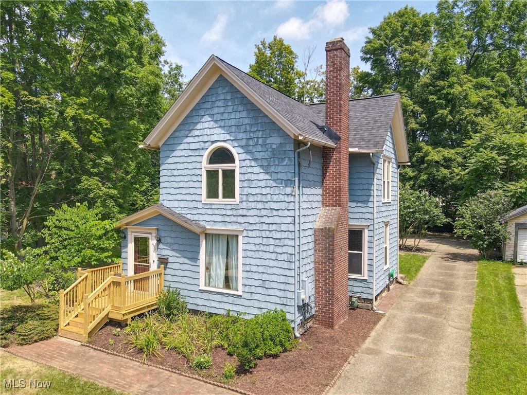 Located just steps from Kent’s vibrant downtown, this beautifully maintained home offers the perfect blend of character, space, and walkability. Enjoy being minutes from restaurants, coffee shops, shopping, and Kent State University. Step inside to find soaring ceilings and an inviting main living area that seamlessly flows between the living room, sitting area, and dining space — ideal for entertaining or relaxing at home. The kitchen offers plenty of cabinet space, a center island, and convenient access to a sun room complete with its own heat source — perfect for a home office, playroom, or creative studio. A half bath and laundry room are tucked away at the back of the home, leading to a detached two-car garage. Outside, enjoy summer evenings on the patio overlooking the partially fenced yard — great for pets, gardening, or gatherings. Upstairs, the spacious primary bedroom features double closets and an updated en suite bath. Three additional bedrooms and a second full bath provide plenty of space for family or guests. The basement is equipped with a radon mitigation and dehumidifier system for peace of mind. This is your chance to own a move-in-ready home in one of Kent’s most walkable locations! Roof-2021, Water Tank-2018.