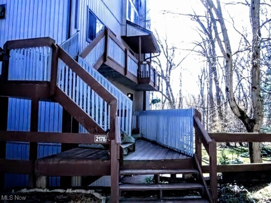 Welcome to this beautifully updated ranch-style condo tucked into the heart of the scenic Merriman Valley. 
The inviting living room features a cozy fireplace, perfect for unwinding after a long day or simply enjoying a quiet enjoying a quiet evening in. The open layout and exceptional natural light paired with new flooring and fresh paint throughout the whole home offer a clean and tranquil environment. 

Both bedrooms boast generous walk-in closets and additional storage. The kitchen is complete with all stainless steel appliances included. The spacious, fully renovated full bath (2022) features a double sink and modern finishes. Through the dining room is the added bonus of a 4-seasons room equipped with sliding glass doors on either side and endless possibilities of use and decor.
Step outside to your private back porch for the serene wooded views and a tranquil pond, creating a year-round retreat right at home. 

Located just minutes from the Cuyahoga Valley National Park, Weathervane Playhouse, popular restaurants and nightlife, and more. Move-in ready so schedule your showing today! The monthly fee includes: Gas, water, sewer, trash, snow removal, landscaping; you only pay electric. One Car garage with remote, and visitor parking spaces.