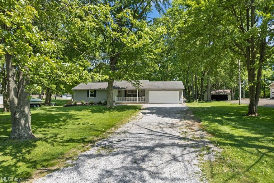 An adorable covered front porch overlooking the spacious front yard greets you upon entering this beautifully renovated ranch in Clinton, Norton City schools! LVT flooring flows through the living room into the remodeled eat-in kitchen featuring clean white cabinets, a pantry and butcher block countertops. Sliding glass doors lead onto a back wooden deck which also provides access to the garage. Both bedrooms are very spacious with the master featuring double closets. What is currently being used as a third bedroom was originally a first floor laundry room with hookups still available, but could also be a great office space. The bathroom has been completely renovated and has a granite countertop. The basement is partially finished while still allowing plenty of unfinished space for storage. Quality updates include: septic tank and windows 2013, flooring and all interior/exterior doors 2019, sump pumps 2023 and so much more! Don’t miss out on this completely move-in ready home!