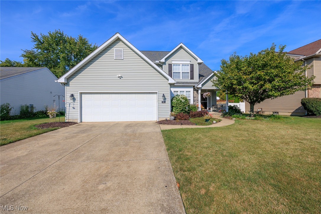 Don't miss this beautifully maintained Dale Yost Colonial offering 4 bedrooms and 2.5 bath with an open, spacious floor plan! The main level highlights a luxurious master suite with a jet tub, shower, and walk-in closet with washer/dryer hook up (washer/dryer negotiable). The stunning living room has vaulted ceilings, skylights, and a gas fireplace encased with a stylish mantel and 2 large windows. Step into the kitchen featuring stainless steel appliances, new backsplash, new sink and faucet, with its own dining area, plus a separate formal dining room/ flex space. Upstairs, a versatile loft connects to 3 bedrooms, a full bath, and a walk-in attic for easy storage. Thoughtful updates include fresh paint, all new LVP flooring, some new appliances, some new ceiling fans, 2 year old tankless hot water heater, and concrete steps to the back patio. Added bonuses include a massive basement in excellent condition, extra-wide 2-car garage, concrete patio, fully fenced backyard, mudroom with custom hall tree, dual washer/dryer hookups in both the master closet and mudroom, app-controlled smart garage door opener and MIDVIEW schools!