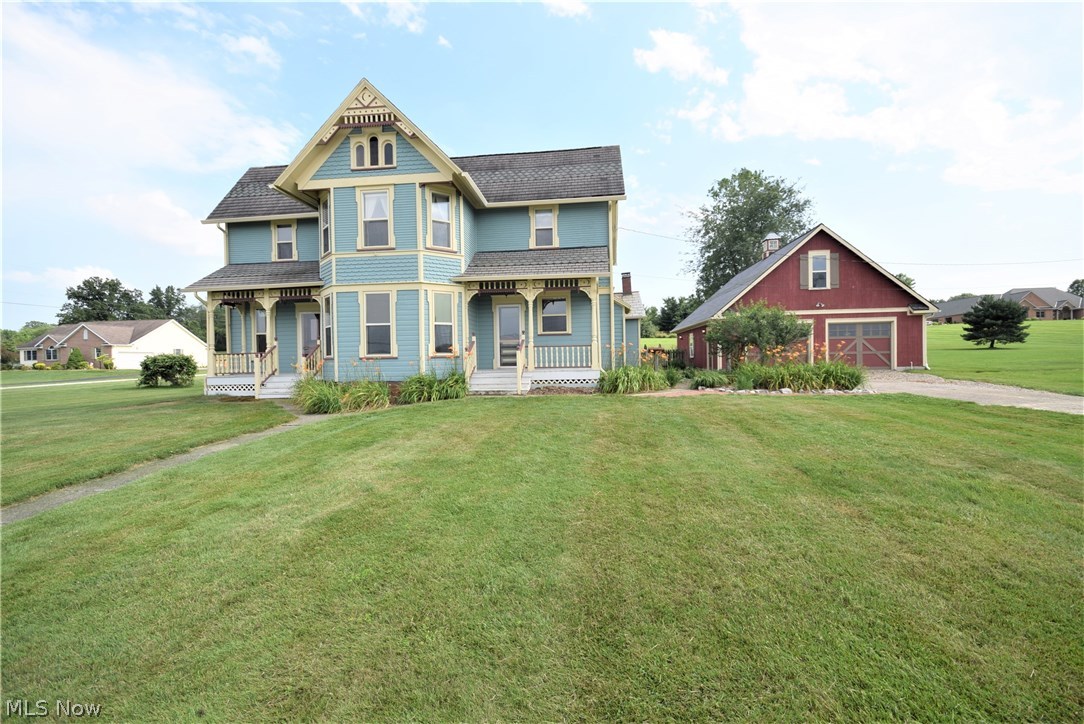 Charming Victorian Century Home with beautiful natural woodwork! This 4 bedroom, 2.5 bath home is warm and inviting! Old world charm with comfort updates! Formal dining room and living room with wood/brick fireplace. Spacious eat-in kitchen and first floor bedroom with hardwood floors. Upstairs there are 3 bedrooms and 2 full bathrooms with beautiful hardwood flooring throughout! First floor laundry. The basement has a newer block foundation, new furnace and air condition, new water heater, updated electrical, newer well pump and radon mitigation system. Gorgeous 4 car garage has a great space for working or storage. The 2.5 acres breathes beauty and freedom into the view from the home's front porch! Come view this home today! Don't wait until it's sold!