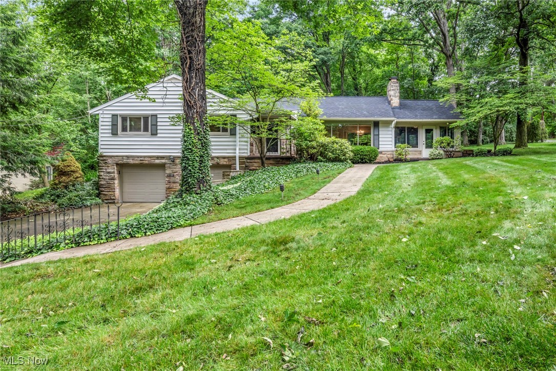 Presenting a Beautifully updated 3 Bedroom, 2.5 Bath Raised Ranch home located on almost an acre of land with a parklike wooded property in the desirable Fairlawn Heights neighborhood.
The light filled Great Room has a large picture window that opens to the dining room & The updated kitchen provides plenty of counter space with all stainless steel appliances included, undercabinet lighting, and dinette area.
An intimate 4-seasons room with gas fireplace and stone surround provids a perfect entertaining area from day to night. Expansive windows provide picturesque views of the backyard and there is access to the deck. The chandelier lit dining area is spacious for formal dinners and gatherings. The owners' suite has en-suite bath with walkin shower while the other 2 bedrooms share an updated hall bath. The lower level finished basement with wood burning fireplace and half bath provide an additional living space for any recreation/hobby or office. The gorgeous exterior of this home has a large deck, brick paver patio and stone water fall feature. Nature Stone floor covers the 2 car garage floor. Copley-Fairlawn Schools, Recent updates include: Replaced all kitchen appliances and washer/dryer (2022), renovated both full baths (2024/2025), installed 200A breaker panel (2023), recessed lighting in living room (2023), bathroom fans (2024), and flue vent (2025), rebuilt pantry (2023), painted deck, front porch, front door, roof (2025), installed fresh landscaping, mulch, rock work in front and back yards (2025), and much more. A complete list of improvements is available upon request. INCLUDED are ALL kitchen appliances, washer/dryer, and a 1-year home warranty. Conveniently located near I-77, OH-18, plenty of shopping, restaurants, parks, and other local attractions.