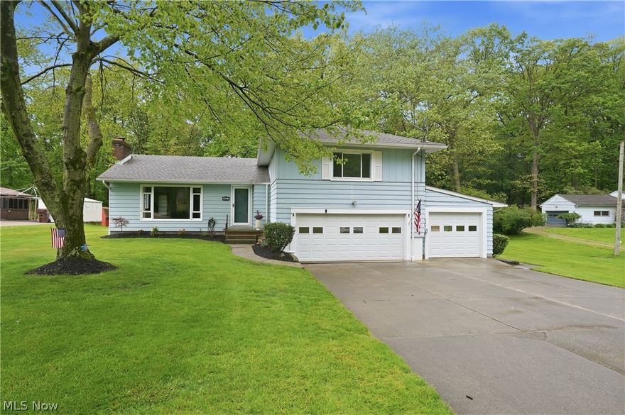 Tucked into a quiet neighborhood on a beautiful 0.76-acre lot, this well-maintained 3-bedroom, 2.5-bath split level offers space, character, and endless opportunity to make it your own. With over 1,500 square feet, mature trees, and a peaceful setting, this home delivers the perfect blend of comfort and privacy.

Step inside to a spacious living room filled with natural light from the oversized picture window, creating a warm and welcoming first impression. The kitchen offers timeless wood cabinetry, generous workspace, and a functional layout ready for everyday living or your future vision. Large bedrooms provide comfortable space to unwind, while the updated baths add convenience and style.

The lower-level family room is packed with personality featuring rich wood detailing, a stone accent wall, and a cozy gas wall heater that creates the perfect atmosphere for movie nights, game days, or gathering with family and friends. A bright enclosed patio room extends your living space even further, offering peaceful backyard views and a place to enjoy every season.

Outside, the expansive yard provides room to garden, entertain, play, or simply enjoy the quiet surroundings. Located close to shopping, dining, schools, and everyday conveniences, while also being just minutes from Portage Lakes attractions and recreation, this location offers both convenience and tranquility.

Major improvements include roof and gutters (2017), gutter guards (2017), windows (2015), living room picture window (2025), bathroom updates (2022), patio room upgrades and windows (2022), hot water tank and sump pump updates, interior painting, garage and basement improvements, exterior lighting, and garage/entry/screen door enhancements. Septic inspection completed October 2024.

Lovingly cared for by long-time owners, this home is move-in ready while still offering incredible potential to personalize and create something truly special.