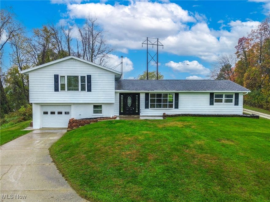 Enjoy peaceful country living in this remodeled split level set on 1.5 acres in East Muskingum Schools. Surrounded by farmland and mature trees, the home features a bright open layout with new flooring, lighting, and paint throughout. The kitchen stands out with white cabinetry, granite countertops, stainless steel appliances, and a peninsula with bar seating that overlooks the spacious living area with a wood burning stove. A full bath is conveniently located on the main level. Upstairs are four comfortable bedrooms with hardwood floors and a second full bath, updated with a tiled step in shower and granite vanity. The lower level includes laundry and utility space plus access to the attached one car garage. Outside, the wide open yard offers plenty of room to relax, garden, or take in the peaceful views, all just a short drive from town. Don't miss out, call today!