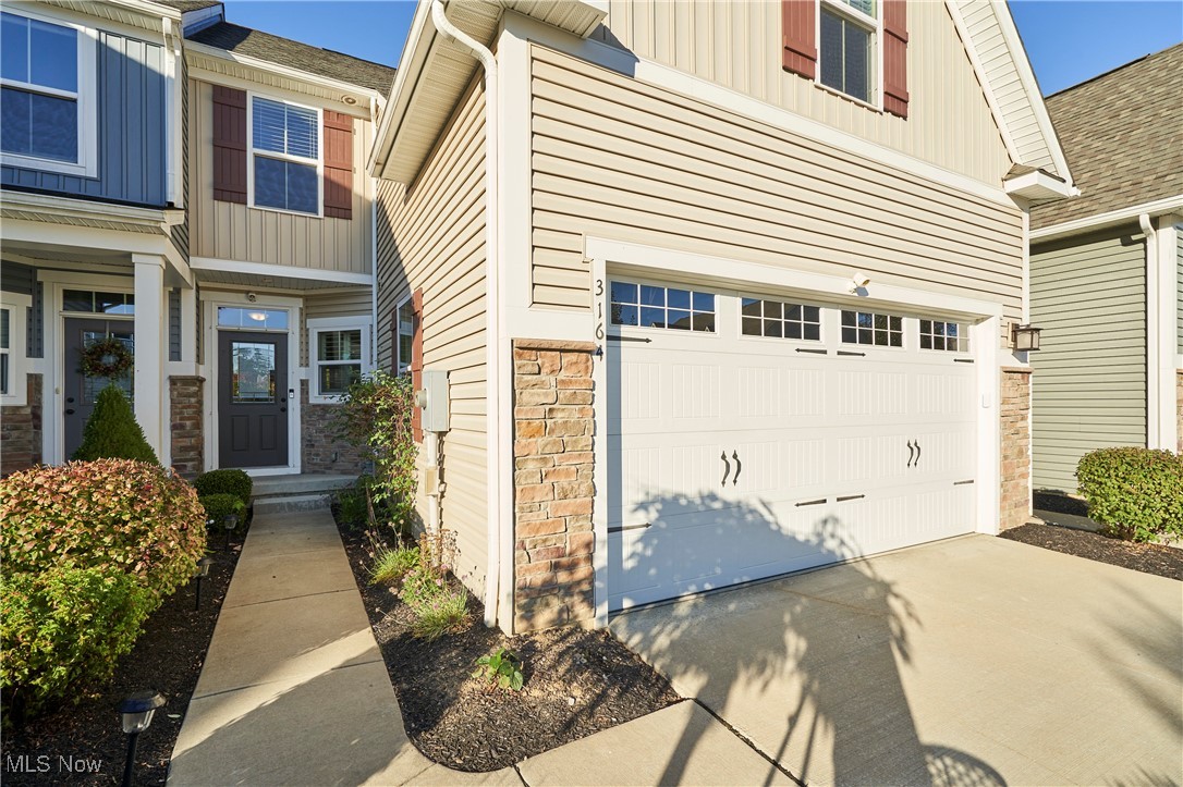 Welcome to this beautifully maintained 3BD, 3.5BA townhome offering modern comfort, thoughtful updates, and a prime location in Cuyahoga Falls. With a first-floor master suite, fully finished walk-out basement, and many recent improvements, this home is truly move-in ready. Step inside to find an open-concept main level featuring a bright living & dining area with LVP flooring (installed in 2022), recessed lighting & large windows that fill the home with natural light. A sunroom attached to the living room adds even more space and versatility and opens to a private deck, ideal for morning coffee or evening relaxation. The kitchen is a standout with granite countertops, white cabinetry, stainless steel appliances, and convenient bar seating, ideal for entertaining or casual dining. The main-floor master suite provides a peaceful retreat with a tray ceiling, LVP flooring, and a spacious en-suite bathroom with double vanities. A laundry room and half bath on the main floor add everyday convenience. Upstairs are two additional bedrooms with plenty of closet space, ideal for guests or a home office, and a full bathroom. The fully finished lower level, with flooring added in 2019, offers a large recreation room, a full bathroom, and double French doors leading to the backyard. Outside, the covered back patio overlooks a lush green space and wooded views, providing a serene setting for outdoor dining or entertaining. Walking trails are planned to be added directly behind the home, offering future access to scenic outdoor paths just steps from your backyard. Additional updates include a new hot water tank (2023), water softener (2023), and an attached two-car garage with stone accents and great curb appeal. Located close to shopping, dining, parks, and major highways, this home combines convenience and tranquility in one perfect package. Don’t miss your chance to own this exceptional property in Cuyahoga Falls. Schedule your private showing today!