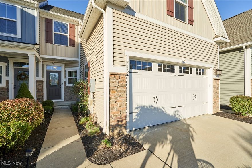 Welcome to this beautifully maintained 3BD, 3.5BA townhome offering modern comfort, thoughtful updates, and a prime location in Cuyahoga Falls. With a first-floor master suite, fully finished walk-out basement, and many recent improvements, this home is truly move-in ready. Step inside to find an open-concept main level featuring a bright living & dining area with LVP flooring (installed in 2022), recessed lighting & large windows that fill the home with natural light. A sunroom attached to the living room adds even more space and versatility and opens to a private deck, ideal for morning coffee or evening relaxation. The kitchen is a standout with granite countertops, white cabinetry, stainless steel appliances, and convenient bar seating, ideal for entertaining or casual dining. The main-floor master suite provides a peaceful retreat with a tray ceiling, LVP flooring, and a spacious en-suite bathroom with double vanities. A laundry room and half bath on the main floor add everyday convenience. Upstairs are two additional bedrooms with plenty of closet space, ideal for guests or a home office, and a full bathroom. The fully finished lower level, with flooring added in 2019, offers a large recreation room, a full bathroom, and double French doors leading to the backyard. Outside, the covered back patio overlooks a lush green space and wooded views, providing a serene setting for outdoor dining or entertaining. Walking trails are planned to be added directly behind the home, offering future access to scenic outdoor paths just steps from your backyard. Additional updates include a new hot water tank (2023), water softener (2023), and an attached two-car garage with stone accents and great curb appeal. Located close to shopping, dining, parks, and major highways, this home combines convenience and tranquility in one perfect package. Don’t miss your chance to own this exceptional property in Cuyahoga Falls. Schedule your private showing today!