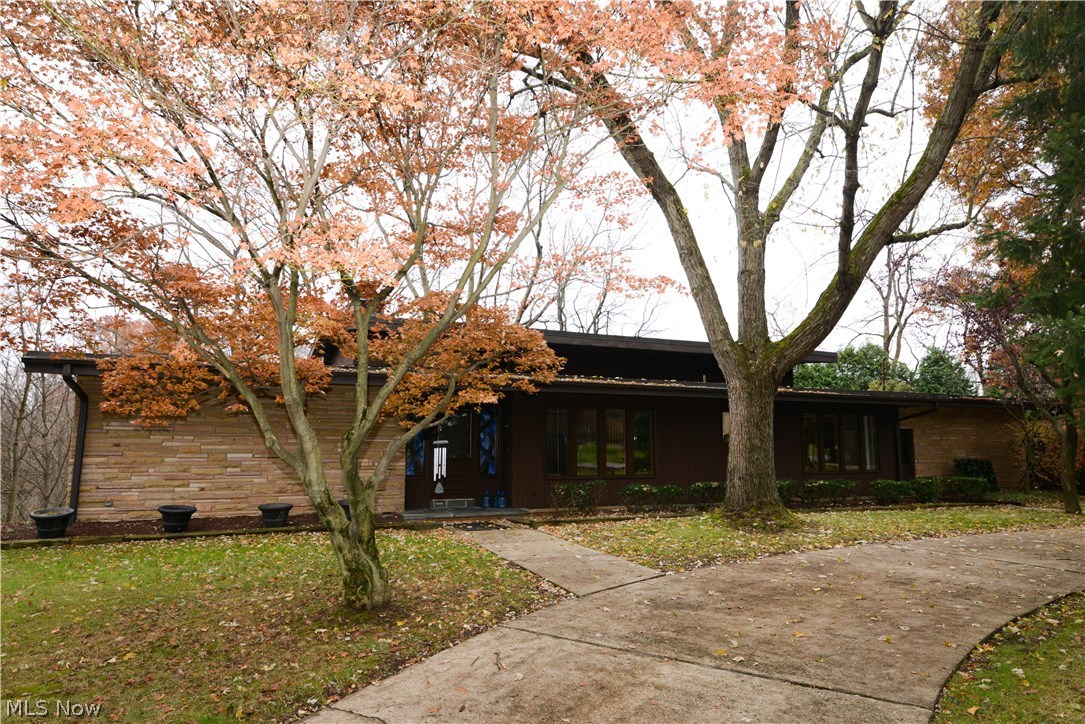 Contemporary designed split on 1.9 acres. Very private surroundings, circular drive.
