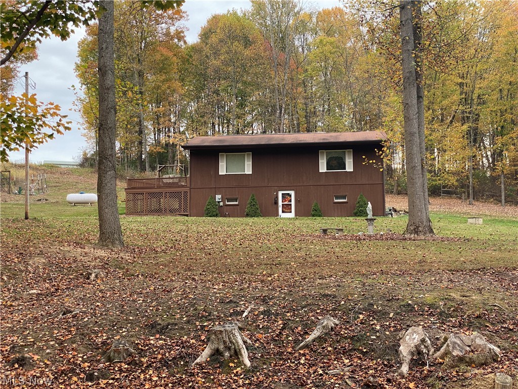 Immaculately Loved Raised Ranch Home with 2 bedrooms, 1-1/2 baths. The bright Living Room is 21 x 14. The Master Bedroom is 15 x 10. Next to the Master Bedroom is a large 8ft x 9-1/2ft Bathroom with shower and jetted tub. The 2nd Bedroom has a sliding door out to the rear deck and pool area. There is a walk-out finished basement with 19 x 12 Family Room featuring a propane fireplace; 23 x 14 pool room & 12 x 7 craft room This property has a 900 square foot outbuilding, The 900 square foot outbuilding also has an upstairs area and 3 wall heaters. The home sits on 2.56 acres with an above ground swimming pool with a very nice deck around it to relax tanning or entertaining family and friends. There is a large vegetable garden area with a 7-foot tall fence as well as a fenced butterfly garden. Extensive cement driveway with a long drive to the house and outbuilding. Next to the outbuilding is a large cement paved parking area. There is a ranch fence around most of the property. Portable generator is included. A 2nd layer of insulation has been added to the attic. The 9 x 12 laundry is bright and clean. Fruit trees and Red Bud trees line the south side of the property.