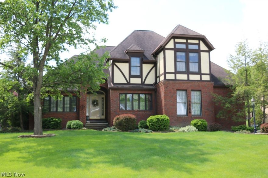 Stunning custom built 4 bedroom, 2.5 bath Tudor featuring every amenity upon entering the distinctive 2-story foyer and gorgeous staircase.  Elegant formal dining room and living room with French Doors lead to library with rich wood paneling, coffered ceilings and custom built-ins. The gas fireplace and coffered ceiling warms the family room that transition into the spacious kitchen and dinette area both of which leads to private wrap around deck and back yard.  Master suite connects to glamour bath, walk-in closet and nursery or private office. Other features of this home include 9' ceilings through out first and second floors, 1st floor laundry, 12 course basement with glass block windows, reverse osmosis, home security system, 2 car attached garage with opener and hot/cold water with center drain.