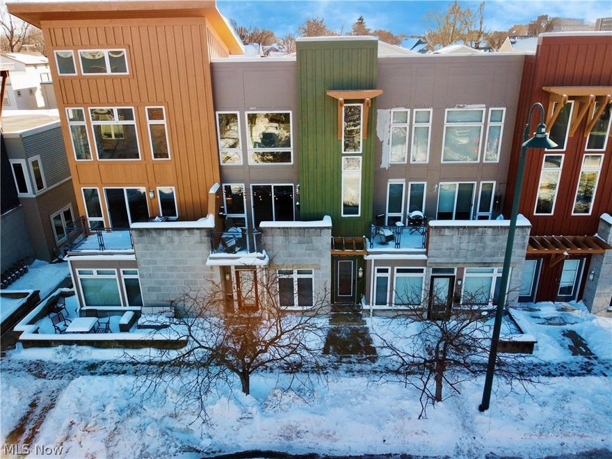 Discover modern living in a beautifully designed contemporary townhome located in the highly desirable and energetic Battery Park neighborhood. This home has big cosmopolitan energy with soaring vaulted ceilings and tall windows flooding all levels with natural light. The open living, dining, and kitchen areas create a seamless flow—ideal for entertaining or relaxed everyday living. Once the Winter chill lifts, step out onto the string-lit private balcony, a cozy spot for morning lattes or enjoying endless sunsets. The kitchen comes complete with stainless steel appliances, granite countertops and island with breakfast-bar seating. The rare full walk-in pantry and private laundry room with a utility sink and storage -are almost unheard of features in nearby townhomes. The main-level bedroom features two generous closets, providing flexibility for family, guests or a roommate who would have their very own designated full bathroom. The Top Level Primary Suite is a truly distinct retreat with a walk-in closet and spa-inspired ensuite bathroom featuring both a shower and a jacuzzi-style tub. A spacious flex-space loft area completes this top floor -currently serving as a family room, but easily adaptable as a home office, guest room or workout space-overlooking the gorgeous neighborhood promenade with Lake Erie Views as a backdrop. Additional highlights include an attached 1-car garage accessed from rear of unit and a new roof planned in the next few months. This unbeatable location puts you close to everything—Lakewood, Downtown Cleveland, and some of the city’s best cafes, restaurants and boutique shops. This neighborhood is rich with nearby amenities including the cycling towpath, Gordon Square Arts District, Capital (Movie) Theatre and Edgewater Park. Also just a short walk to the beach (you’ll love that soon enough!). All this, with only an 18-minute drive to the Cleveland Clinic. Experience contemporary living with a vibrant, urban edge—right here in Battery Park.