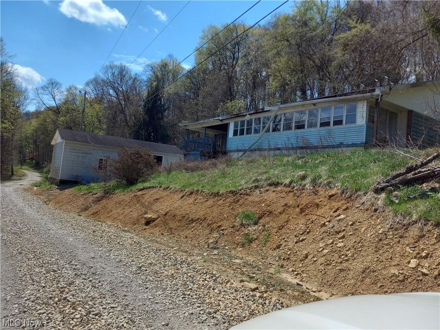 The property has a 1984 doublewide on a full foundation with a walkout basement. 2 Acres have been cleared the other 3 are wooded.  Home is Unhabitable at the present.  Handyman special.  All heating & cooling, appliances & floor coverings have been removed.  There is a 24x48 pole barn/garage without doors on the property.  There are two drilled wells and a septic system.  Land lays on both sides of the road.