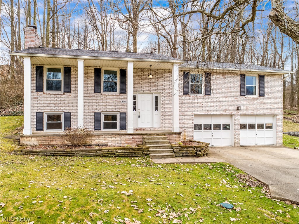 This beautiful brick home offers the ideal country setting with the oversized front porch featuring gorgeous 2 story columns. Once inside, you are welcomed into the living room full of natural light. The kitchen includes stainless steel appliances and modern updates featuring beautiful wood flooring. The wood wood flooring extends into the dining area with sliding doors to the sunroom. The large sunroom overlooks the fully fenced backyard and offers an ideal place for your summer entertaining. The main floor also includes 3 large bedrooms. The master bedroom has convenient access to the remodeled bathroom. The lower level includes a spacious family room with brick wood burning fireplace and plenty of sunlight. Also is another large bedroom on lower level with a fully remodeled bathroom. Other updates include newer windows, water softener, roof, carpet, paint, flooring, much more!