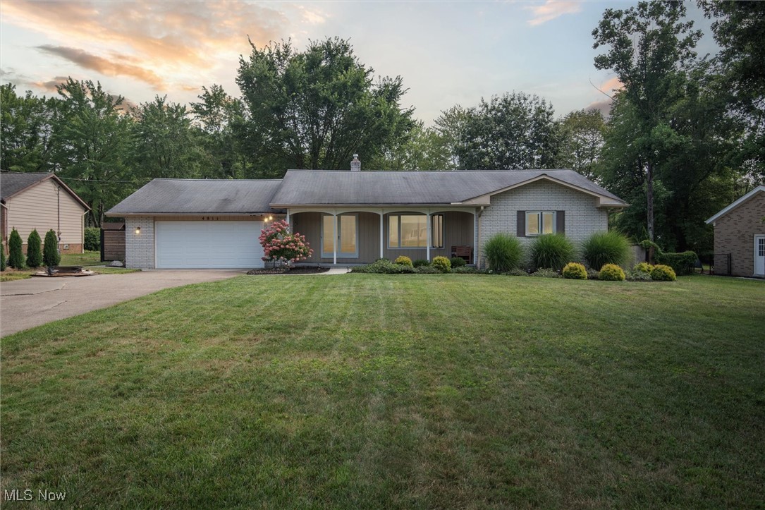 Welcome to this beautifully updated ranch home offering over almost 3,000 square feet of flexible living space designed to fit a wide range of needs, including multi-generational living. From the moment you arrive, you're greeted by a large, inviting front porch and a grand double-door entry that opens into a spacious living room with an oversized window, newer carpet, and tons of natural light. The heart of the home is the fully remodeled kitchen, boasting quartz countertops, modern cabinetry, stylish fixtures, new flooring, LG appliances, a breakfast bar and a large island with sink. A charming bay window provides the perfect spot to enjoy your morning coffee. The main floor includes three generously sized bedrooms, all updated with new flooring, closet systems, and lighting. One of the bedrooms features an en suite full bath and can serve as a primary suite or it can become part of the fully equipped in-law suite. Perfect for extended family or guests, the in-law suite offers its own kitchen, dining room, and large living room—plus private access through two separate doors leading to the patio and deck. Sliding glass doors open to a sprawling, fully fenced backyard with a brand-new patio and gate—ideal for entertaining, pets, or play. Both full bathrooms have been tastefully updated, and the laundry has been conveniently relocated to the first floor. Downstairs, you'll find a huge finished rec room—perfect for a gym, office, game room, or additional lounge space. Lovingly maintained and thoughtfully updated over the past 5 years, this home combines charm, modern convenience, and layout flexibility like few others. Whether you're looking for a forever home or a property that can grow with your family, this one checks every box. All of this and in an amazing location close to parks, schools, restaurants, shops and more. Just move in and enjoy!