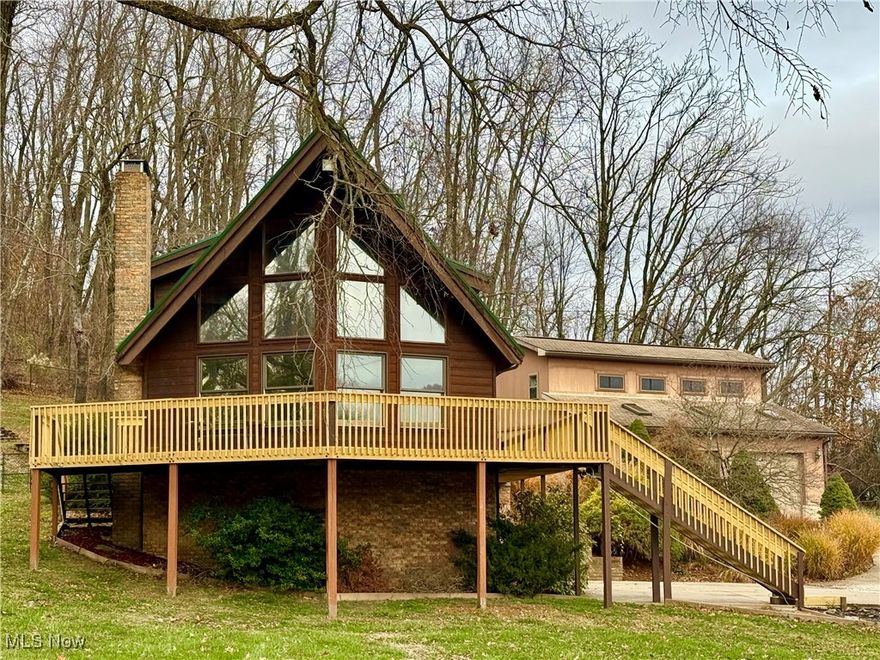 Discover peaceful, serene country living at 70 Fox Run Rd New Cumberland WV. Set on 1.23 picturesque acres, this unique cedar A-frame home blends rustic charm with modern comfort in a location that feels private and rural, yet is just one mile from County Rd 2 and close to everything you need. Step inside to find soaring vaulted ceilings, abundant natural light, and a layout designed to capture the gorgeous views surrounding the property. The home offers 2 bedrooms and 3.5 baths, providing comfort and flexibility for everyday living or weekend retreats. Recent upgrades include a new metal roof (2023) and new decking (2025), ensuring long-lasting enjoyment and peace of mind. Outdoor living is unmatched with an enormous wrap-around deck and custom fire-pit, perfect for taking in the tranquil setting, entertaining guests, or simply relaxing with nature as your backdrop.
Car enthusiasts, hobbyists, or those needing workspace will appreciate the attached 2-car garage plus a spacious 32’ x 32’ detached garage featuring a workshop area and a 26 x 11 finished office with half bath—ideal for remote work(high speed internet available), creative pursuits, or small business needs.
A rare opportunity to own a home that offers both convenience and true country serenity, this property is the perfect blend of comfort, character, and breathtaking surroundings. Don’t miss your chance to experience the peaceful lifestyle that awaits at 70 Fox Run Rd.