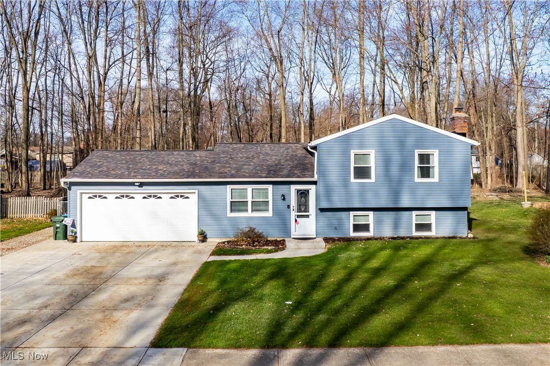 Welcome home to this well-maintained 3 bedroom, 2-bathroom split-level nestled in the heart of Brentwood Estates in Olmsted Township.This home sits on an impressive 1/3-acre fenced lot with serene wooded views to offer both privacy and a peaceful backdrop. Inside, the refreshed kitchen has painted cabinetry, stainless steel appliances, granite countertops, and a stylish backsplash provides plenty of space for prepping, cooking and baking. The large dining area is a great place for meals and offers flexibility in the space with its open layout. Walk down a few steps to the spacious family room, featuring a brick wood-burning fireplace and ample seating space that is perfect for gatherings. Finishing this level is an updated full bathroom and convenient laundry/utility room. Upstairs, the generously sized bedrooms offer comfort, and another updated full bathroom makes it easy to get ready for the day. Outside, there is a newer stamped concrete patio perfect for outdoor entertaining or enjoying the view of the beautiful scenery. Recent updates provide peace of mind, including newer windows, roof, siding, driveway, and a waterproofed lower level with a transferable warranty. With its amazing location, thoughtful updates, and expansive yard, this home is a true gem. Come see today!