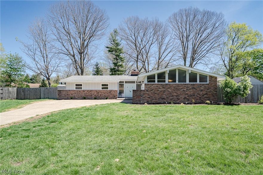 New to Market: 7483 Carole Dr in Mentor! This charming mid-century modern ranch blends timeless style with thoughtful updates, a bright, open layout, and a great location. Enjoy close access to both major highways in the area and the convenience of being right around the corner from the main library on the next street over.

A welcoming entry opens into a foyer with classic slate tile flooring, offering a warm and inviting first impression.

The foyer flows into a spacious living and dining area designed for comfort and connection. The open layout is ideal for both everyday living and entertaining. It features LVP flooring, a beamed ceiling, and large windows that fill the space with natural light. The living room is anchored by a striking sandstone fireplace that adds character and warmth.

The kitchen offers a functional and efficient layout with tile countertops, a matching backsplash, ample cabinet space, and a full appliance package. Just off the kitchen is an informal dining area or flex space with built-ins and LVP flooring. Sliding doors open to a sunroom, extending the living space.

The sunroom is currently used as an office or optional bedroom, providing flexibility for a variety of needs. A convenient half bath is located nearby.

On the opposite side of the home are three well-sized bedrooms. The primary bedroom includes direct access to an updated full bathroom, creating a comfortable and semi-private retreat.

This home offers a blend of mid-century charm, modern updates, functional living, and an unbeatable location in desirable Mentor.