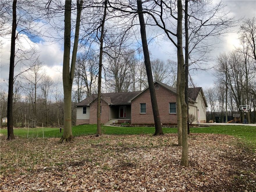 Norwayne Schools ~ You will fall in love with this well cared for, spacious, 3800 square feet of finished living space, 5 bedroom, 3 full bath brick and vinyl ranch nestled on 2.75 gorgeous, wooded acres! Upon entering, you will be "wowed" by the cathedral ceiling and newly re-finished hardwood flooring in the great room with beautiful stone fireplace and wood burning fireplace insert. Step out onto the large deck with a view of your backyard play area, woods and abundant wildlife.  The fully applianced kitchen with new stainless steel appliances, beautiful hickory cabinets, pantry with roll out shelving and corian countertops is open to the dining area and great room making it an ideal entertaining space. 3 spacious bedrooms on the main level all have newer carpet.  The master bed/bath has double sinks, walk-in closet, soaking tub and separate shower plus doorway access to the deck. The finished, walk-out lower level contains a massive recreation room, office, full bath and 2 addition