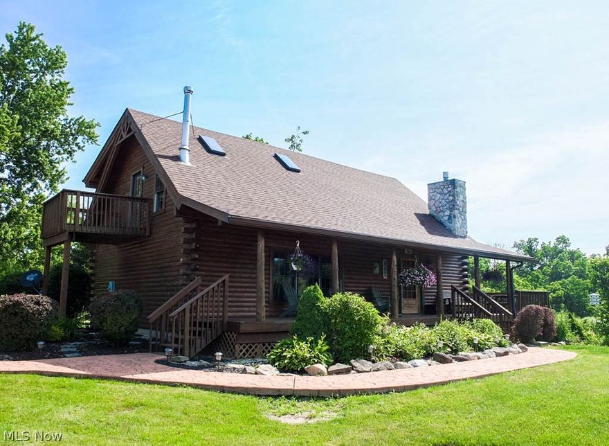 Sitting on over 6.5 acres with a private, stocked pond, this sun-filled log cabin offers a serene setting with ample amenities! The open floor plan features many attractive design elements including beautiful wood flooring, vaulted ceilings with wood paneling and numerous windows with scenic views! The gorgeous 2-story great room showcases a stone corner fireplace. The kitchen offers granite countertops, a breakfast bar and comes applianced with a refrigerator, range, oven and dishwasher. Enjoy views of the pond from the open dining room and kitchen. There's a convenient laundry room with half bath on the main level - a nice extra! First floor master suite has a walk-in closet and a pocket door to the private full bath with corner jetted tub, separate shower, linen closet, tile flooring and tub surround. Upstairs, there's a junior suite with a 9x7 walk-in closet, a private balcony overlooking acreage and a private full bath with a claw foot tub and vaulted ceiling. You'll love the impr