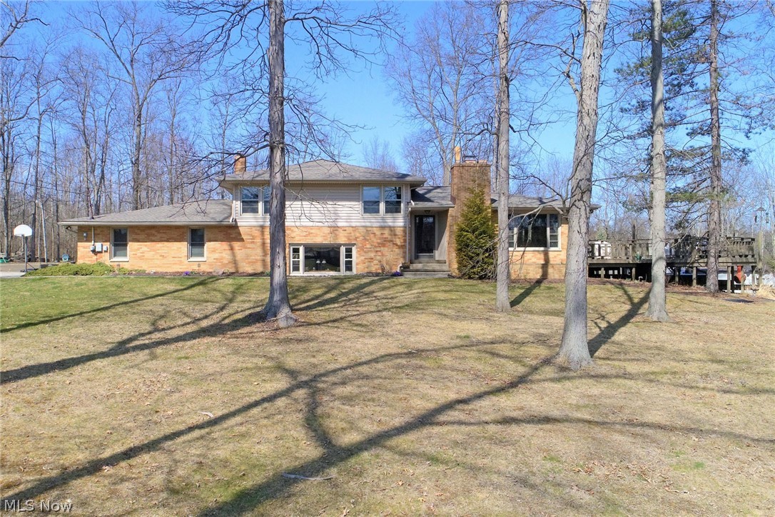 (Rootstown Township and schools) Beautiful park-like private setting on nearly 7 acres perched high with scenic views. Three bedrooms, two full updated bathrooms and 2,344 s.f. of living space! The lower level hosts a spacious family room w/ wood burning fireplace, bay window overlooking the front acres, full bathroom w/ new tile shower, and laundry. The main floor holds a quality kitchen with granite and center island, dining area, living room and heated floors! Upstairs are three bedrooms, a second full bath and hardwood floors. The home is in excellent condition with many updates; new roof 2020, new heating system 2015 (also outdoor wood burner to supplement heat – under warranty), updated windows, kitchen appliances 2018, lower bathroom update 2021. Two car heated attached garage; two car detached 24x32 garage w/ heat/water/electric & sitting porch; 16x32 ag. building/horse barn. Mature fruit trees. Two tier deck w/ swimming pool and hot tub included! Move in ready! Schedule your showing today!