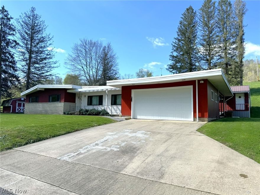 Welcoming Mid-Century Ranch in Calhoun County, WV - Discover this charming 3-bedroom, 1.5-bathroom ranch home, nestled on a peaceful 0.52-acre lot just 4 miles from Grantsville's conveniences like stores, hospitals, and dining. Featuring a single-level layout that exudes mid-century charm, the home includes a large living room and a cozy den, both anchored by inviting fireplaces and perfect for relaxation or hosting. Step out onto the expansive 12x36 deck, ideal for outdoor entertainment and enjoying the tranquil country surroundings. The home is fully equipped for comfort with a furnace, central air conditioning, and all essential appliances included, making it move-in ready. Utility-wise, the property is well-appointed with electricity, natural gas, city water, and a septic system. Additionally, it boasts a large cistern that efficiently collects rainwater. Practicality extends to the ample storage and workspaces; a spacious 20x22 attached garage complements a 15x19 workshop—perfect for woodworking or potential conversion into an apartment. An extra 12x12 outbuilding provides additional storage for equipment. Located in the 100-year flood plain, the home will require flood and homeowners' insurance, though it has never been flooded, as per the current owners. Situated at 3444 Russett Road, this charming ranch offers a blend of comfort, convenience, and country charm, making it an ideal choice for those seeking a serene lifestyle close to town amenities.