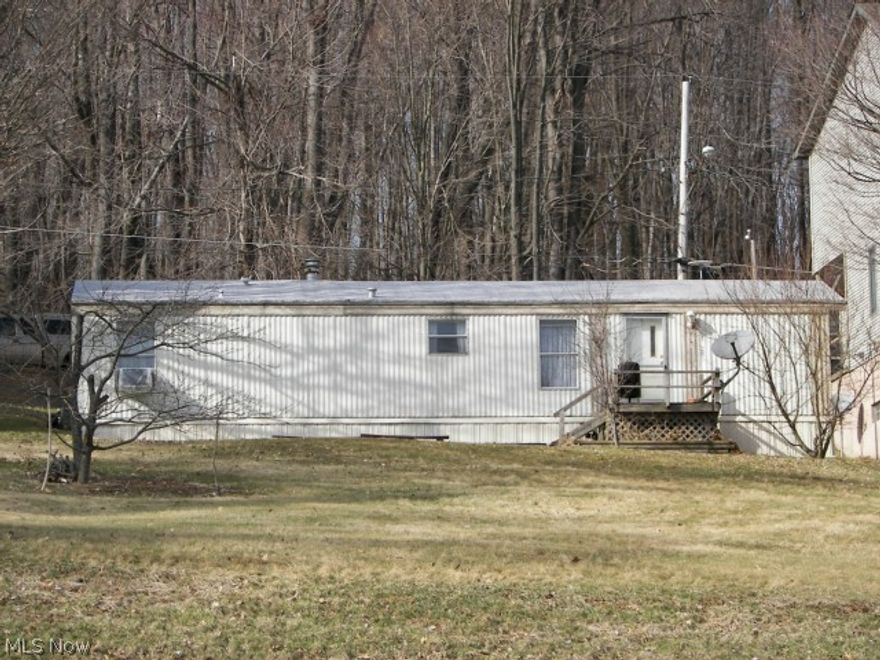 Wanting a vacation spot! This property has a good view of Guilford Lake, lot has been newly surveyed. 700 sq ft two bedroom, 1 bath 1997 Skyline mobile home with 3 car parking space. Close to beach and picnic area.