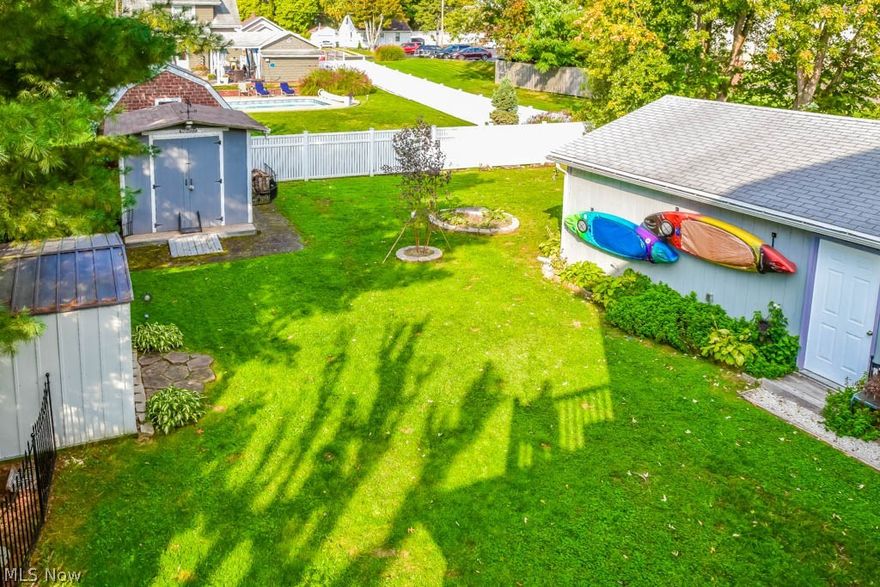 Charming 3 bedroom, 1.5 bath cottage-style home in Perry! Beautifully redone with a new driveway, gorgeous landscaping and tons of updates. Lots of character inside with wide trimwork, tall ceilings, built-in dining room cabinets, plus wood flooring and a woodburning fireplace in the living room. An arched front door leads you into a welcoming foyer with a coat closet and glass paneled door to the living room. Applianced kitchen with maple cabinets, tile flooring, a laundry chute, spice cabinets and Corian countertops. The half bath on the main level has an updated vanity and linen storage. Upstairs, all 3 bedrooms have hardwood floors. The master bedroom has 2 closets while bedroom 2 has a private balcony! The main full bath has tile flooring, an updated vanity and a laundry chute just outside the door. Access to the walkup attic - the perfect storage space or it could be finished for an extra room! Updates include electrical, plumbing, new A/C, high efficiency furnace and roof! Lovel