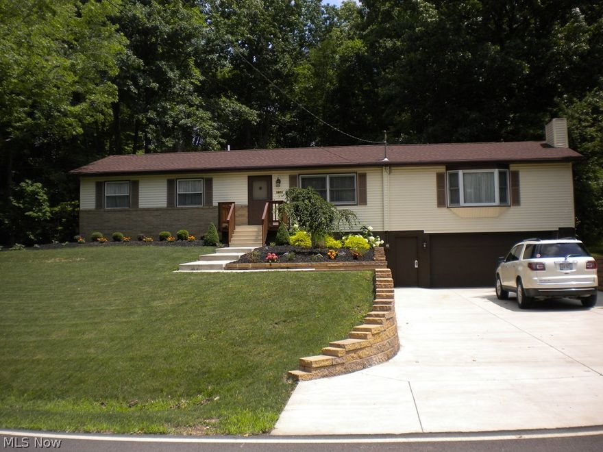 What a fabulous kitchen with maple cabinets, granite counters, pull-out drawers, and island.  The great room has plenty of space with a wood burning fireplace.  The dining room is oversized with beautiful built ins.  Updates include roof and furnace (2011), water heater (2012), large concrete driveway and beautiful landscaping and electric (2014)