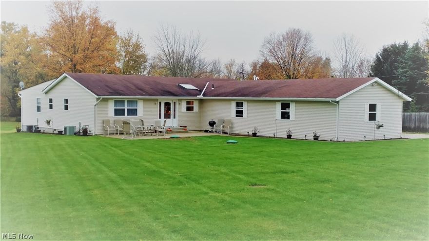 The opportunities are endless in this one of a kind ranch home with 4 car, heated, attached garage and 24x34 Outbuilding. Businesses welcome, Zoned light industrial in Eaton Township, Midview Schools, North Ridgeville Mailing address.  The home sits on just over an acre with a creek, you can enjoy the views from the 14x50 ft. back deck. You won't believe the kitchen! It has Granite counter tops, 2 islands, tons of cabinets, Ceramic floors, Stainless appliances, with an open floor plan is great for entertaining! 2 Suites in the 5 bedroom, 3 full bath and 2 additional half baths and is 2600 square feet of one floor living! There is also a front patio and double wide, newer drive way and tree house! 2 newer furnaces and a/c units, newer windows and freshly painted. Don't miss this one!