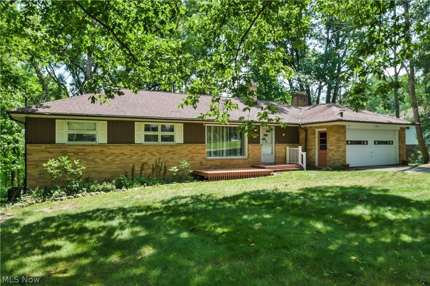 Located on a quiet street this 4 bedroom 2 bath home has plenty of space for the family or for someone downsizing who wants ranch style living.  Situated on a quiet street this home has a walkout lower level and is on 1.57 acres. There is a totally wooded parklike view to the rear.  Upon entering this home you are in a large living room with an L shaped dining room adjacent. Large windows in the dining room overlook the yard and the applianced kitchen also overlooks the back. The floor plan is that of a California split with the master bedroom on one side of the home and a full bath adjacent and then there are 3 other nice sized bedrooms with hardwood floors and full bath on the other side of this home.  Besides a large lower level rec room there is a great 3 season room with a wood ceiling, a fireplace and is the perfect place for nature watching.  A newer roof and furnace accent this home.